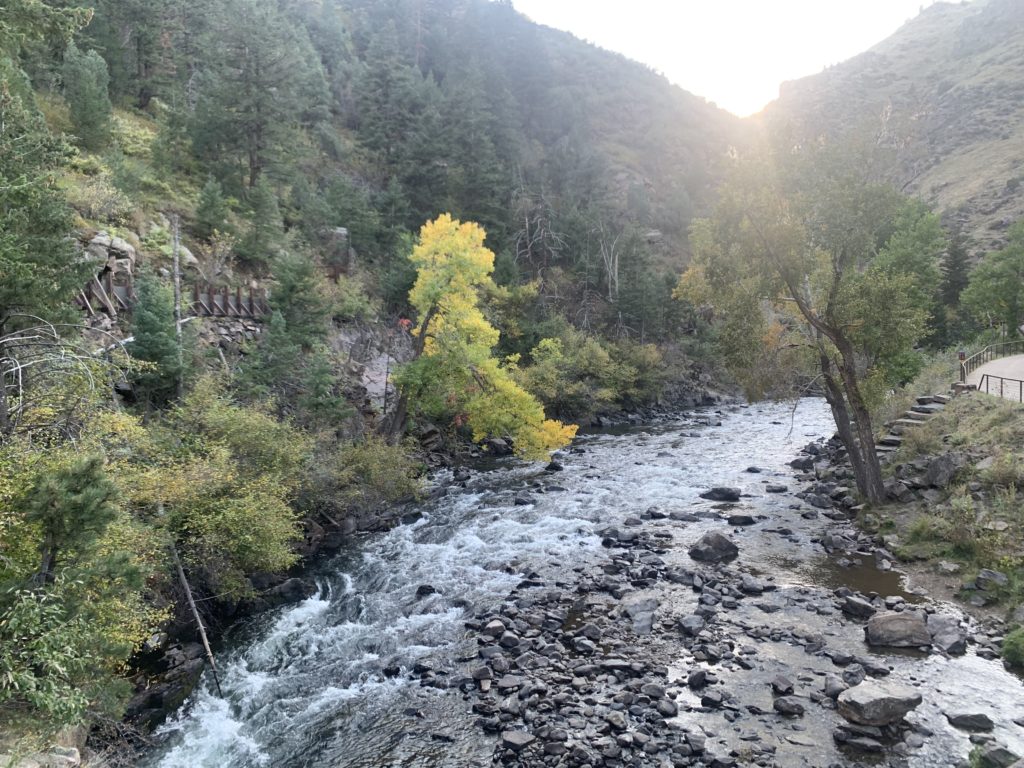 A river flowing through a canyon with trees in the background.  A hike for kids in Golden.