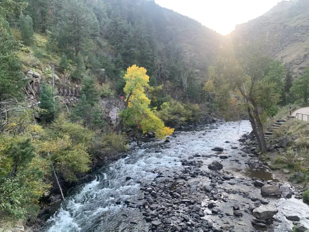 A river flowing through a canyon with trees in the background.  A hike for kids in Golden.