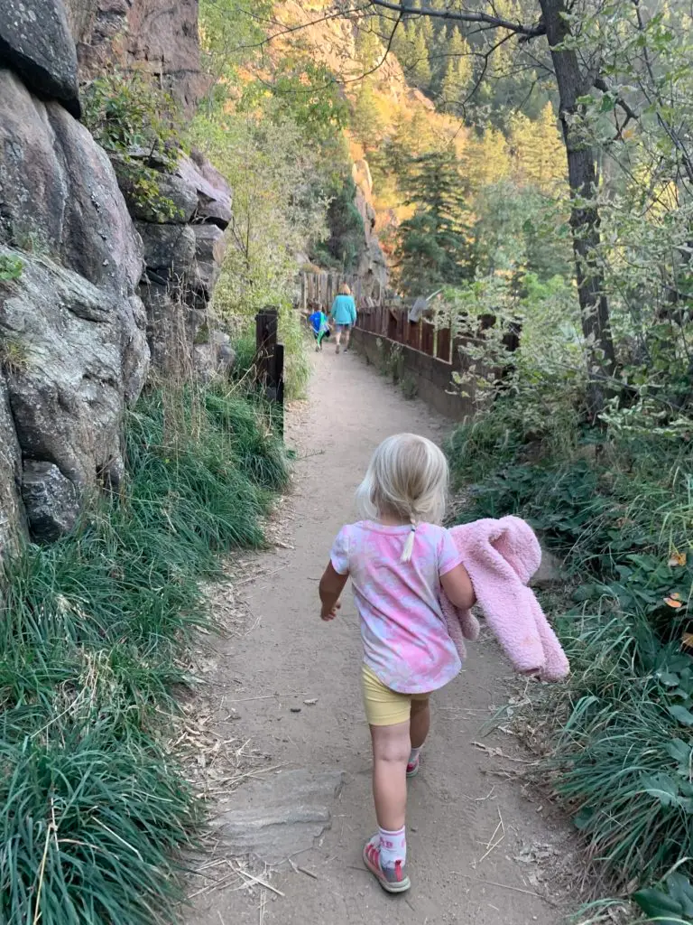 A little girl walking down a trail on a hike for kids in Golden.