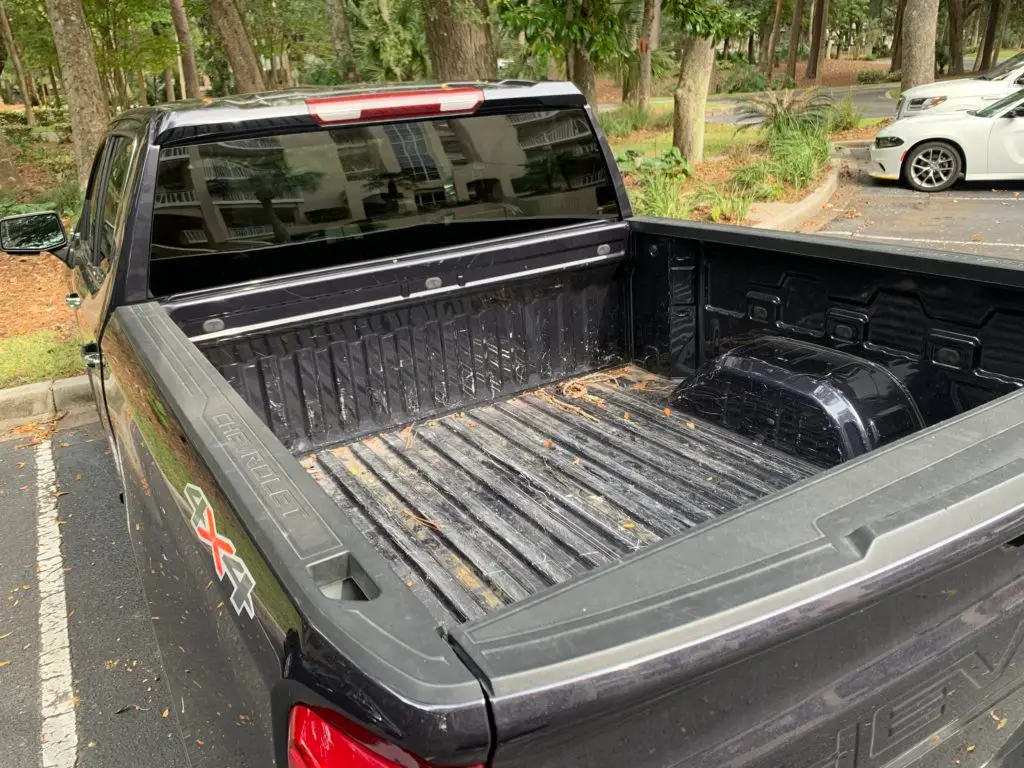 A black truck parked in a parking lot.  The best rental car for families.