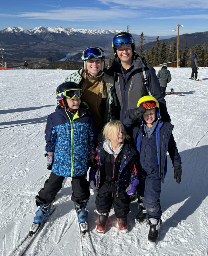 A family on skis posing for a picture.