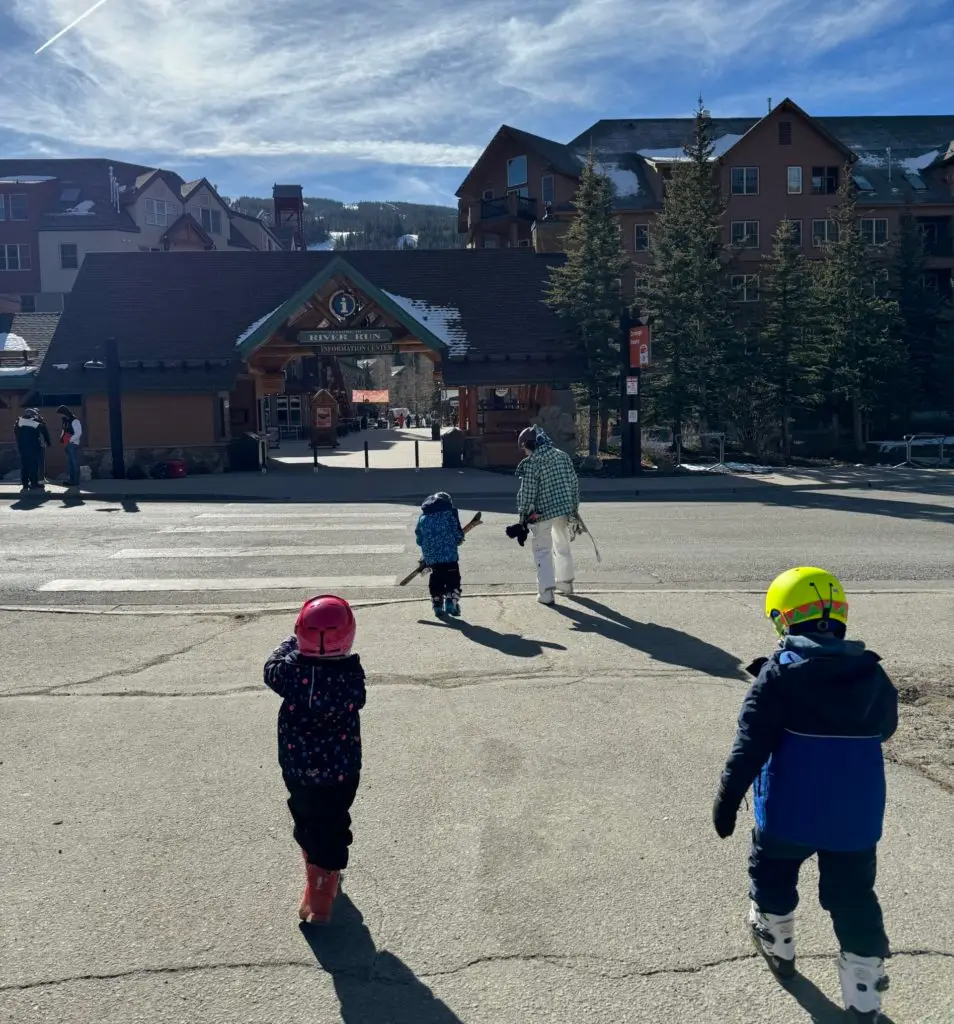 A group of children walking in front of a building.