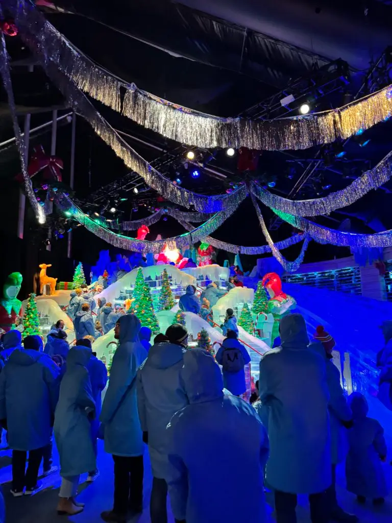 A group of people are standing in front of a snow globe.