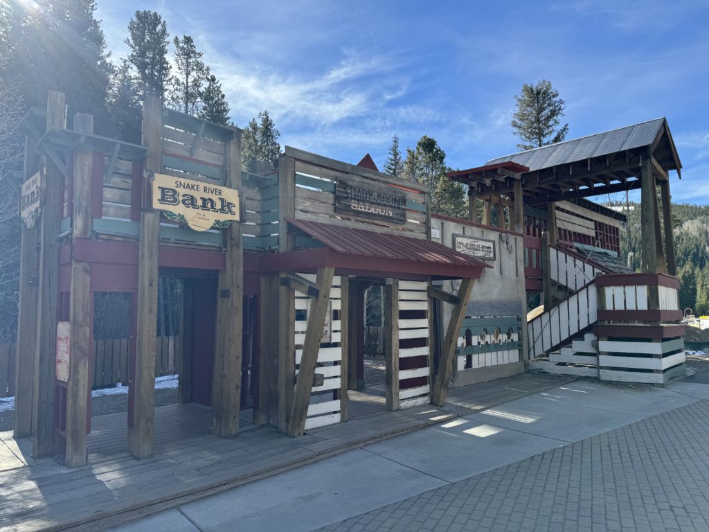 A wooden building with a sign on it at Keystone Resort, making it a best ski resort for kids. 