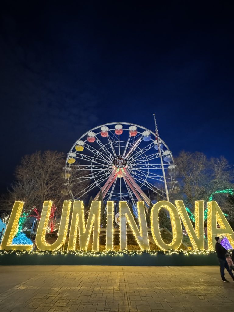 A ferris wheel with the word luminova in front of it.