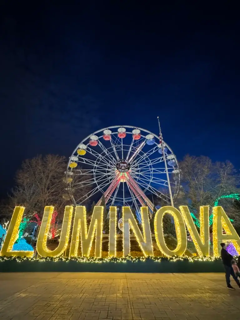 A ferris wheel with the word luminova in front of it.