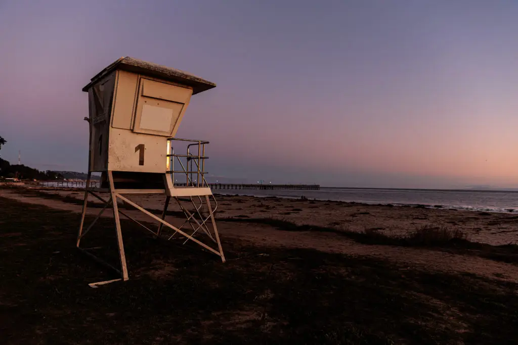 A lifeguard tower on a beach at dusk. Beaches in Santa Barbara With Kids