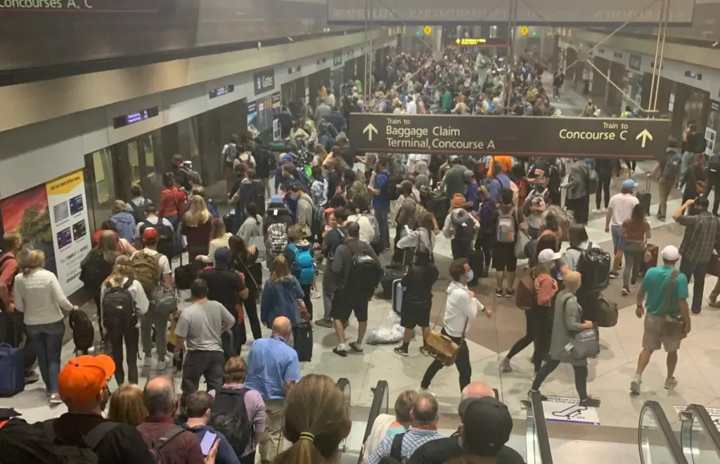 A large crowd of people in an airport. A reason for is clear worth it for families