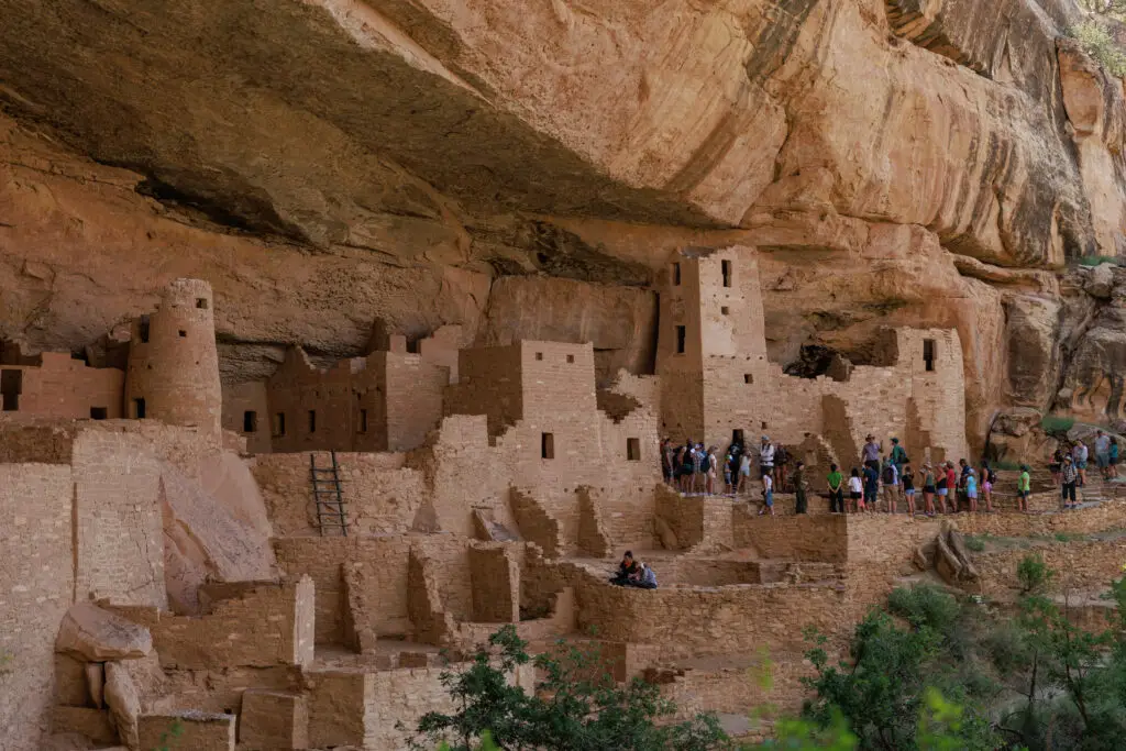 At Mesa Verde, families can embark on an educational adventure with kids as they explore the ancient cliff dwellings built into a rocky overhang, captivating the imaginations of curious tourists.  Mesa Verde with kids.