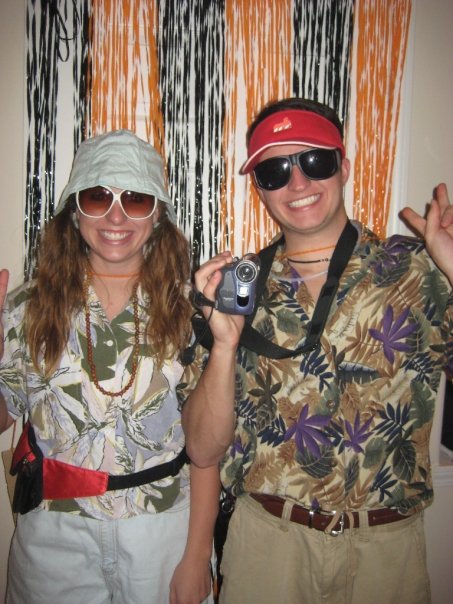 A man and woman dressed in hawaiian shirts and sunglasses embark on a travel adventure.