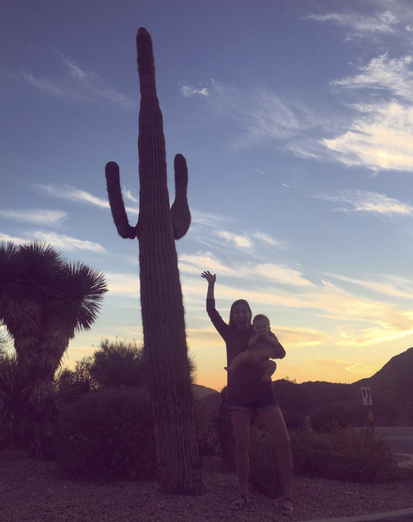 A woman's adventurous spirit in front of a saguaro cactus.  Arizona makes one of our picks for warm destination ideas.