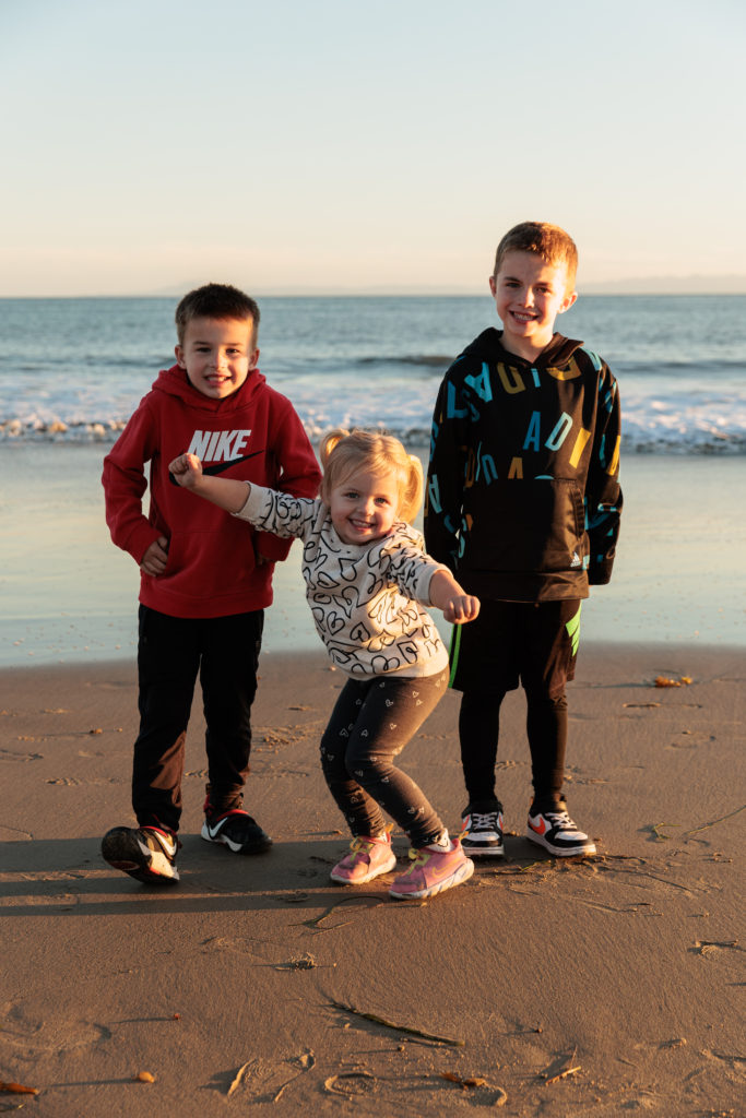 A group of children standing on a beach. Beaches in Santa Barbara With Kids