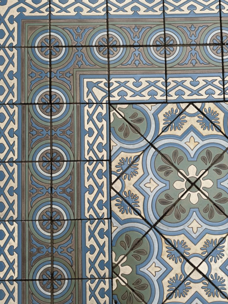 A tile floor with a blue and white pattern. State Street with kids.