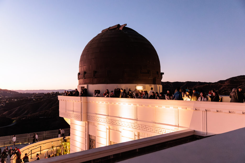 Griffith observatory with kids at dusk.